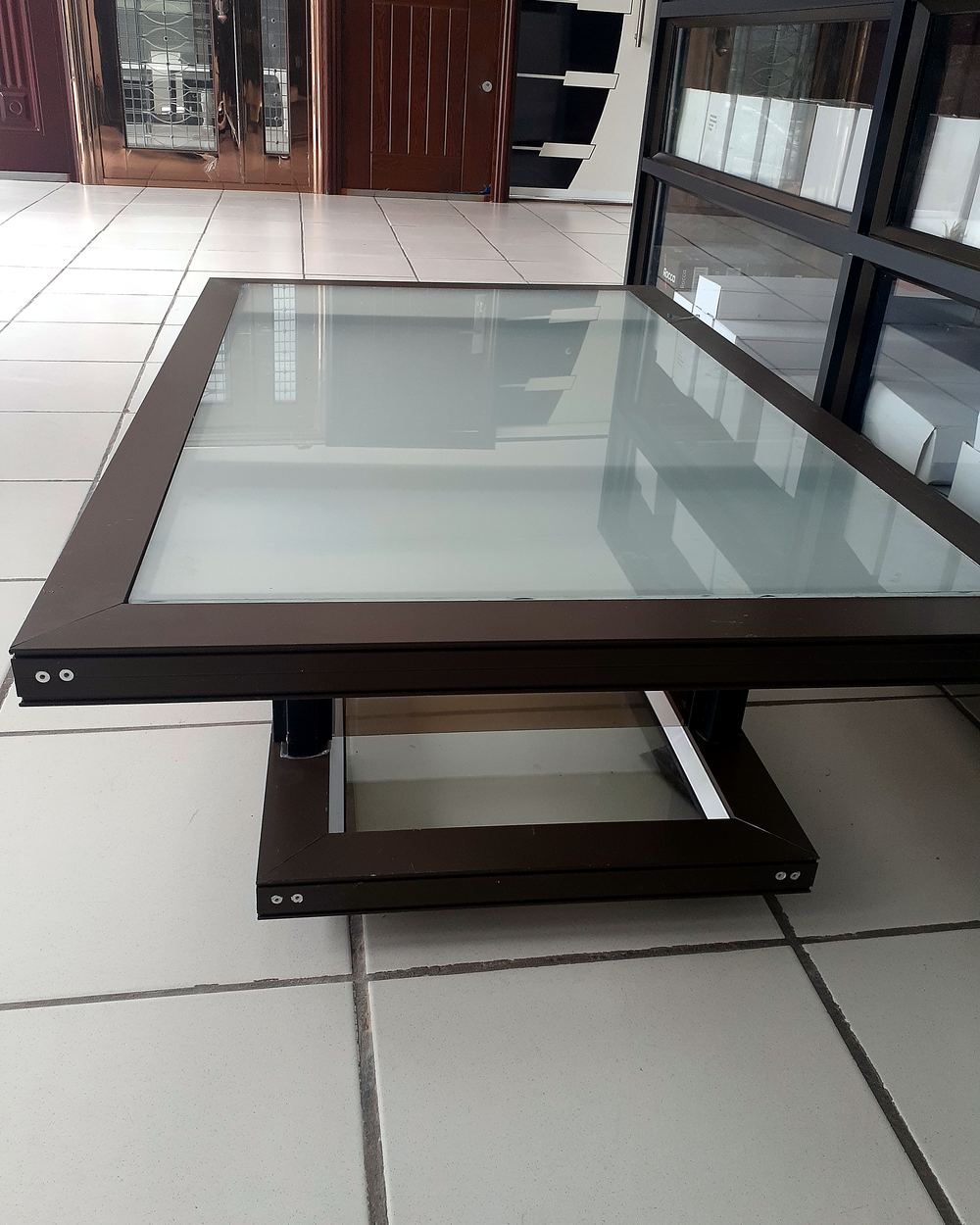 Aluminium-framed glass table in our showroom